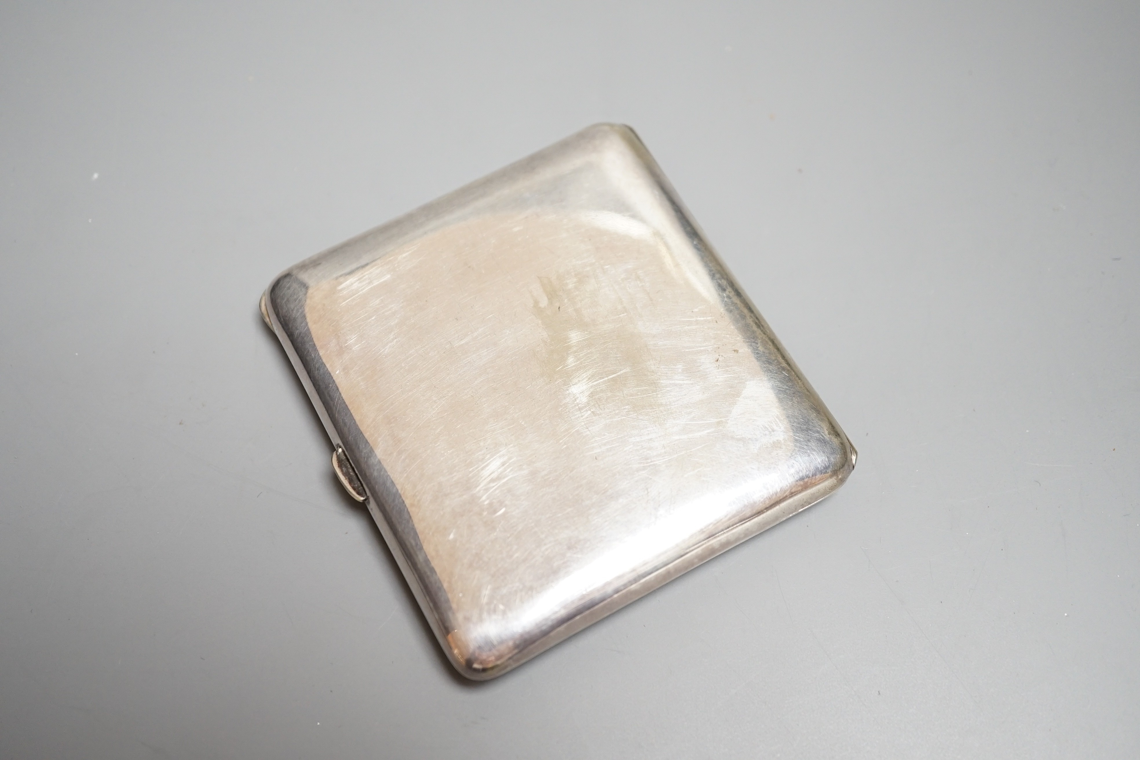 A Continental silver plated cigarette case, early 20th century, lid with erotic enamel scene of naked lady standing in front of a cheval mirror, gilt interior stamped ALPARP, height 8.5cms.